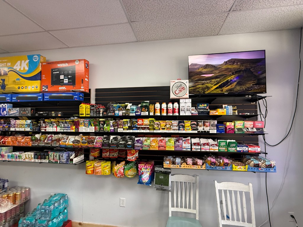 Display shelves with devices and flavors at Dillard Vape and Lotto